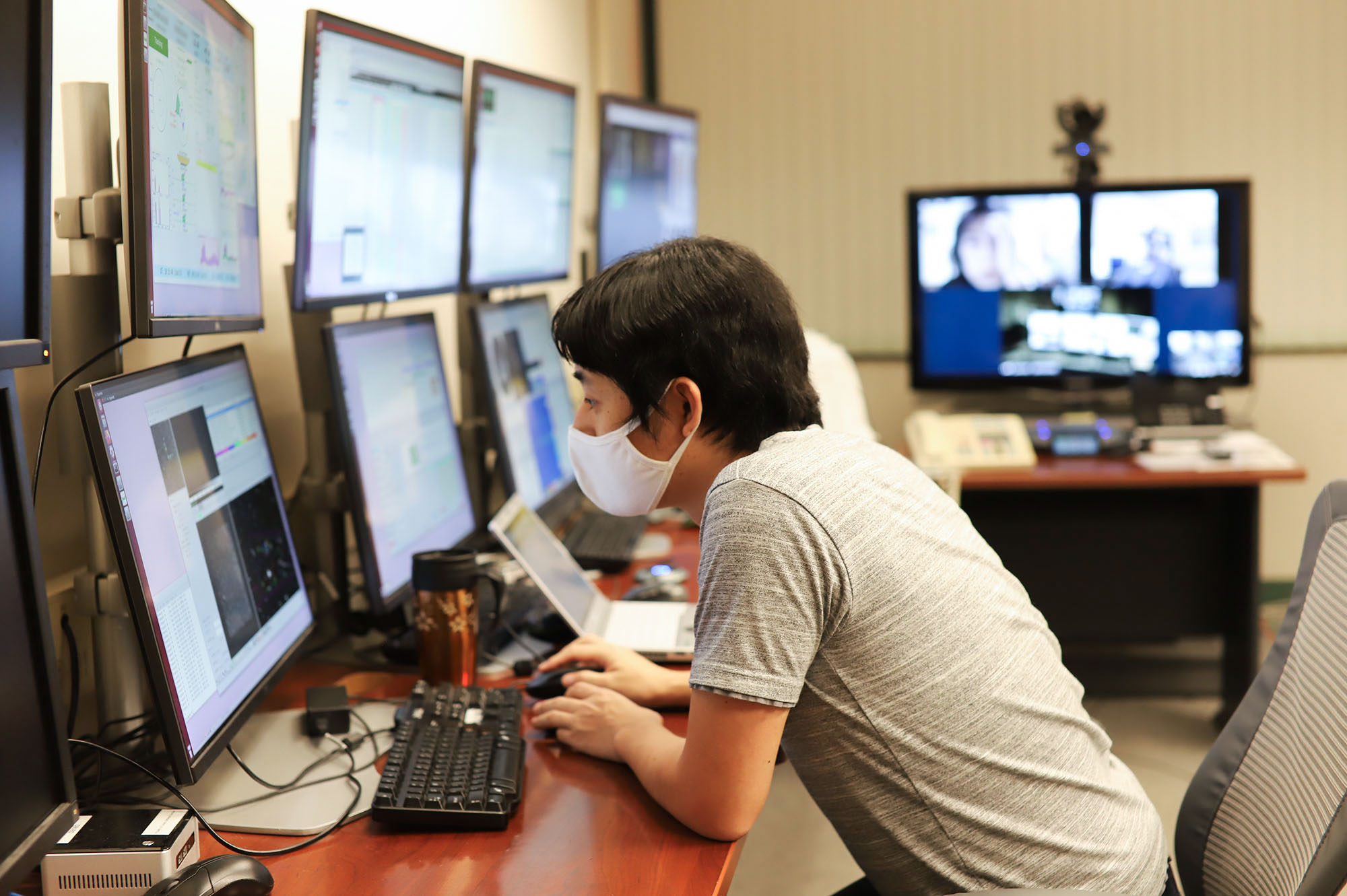 Dr. Tsuyoshi Tera at a workstation with many monitors