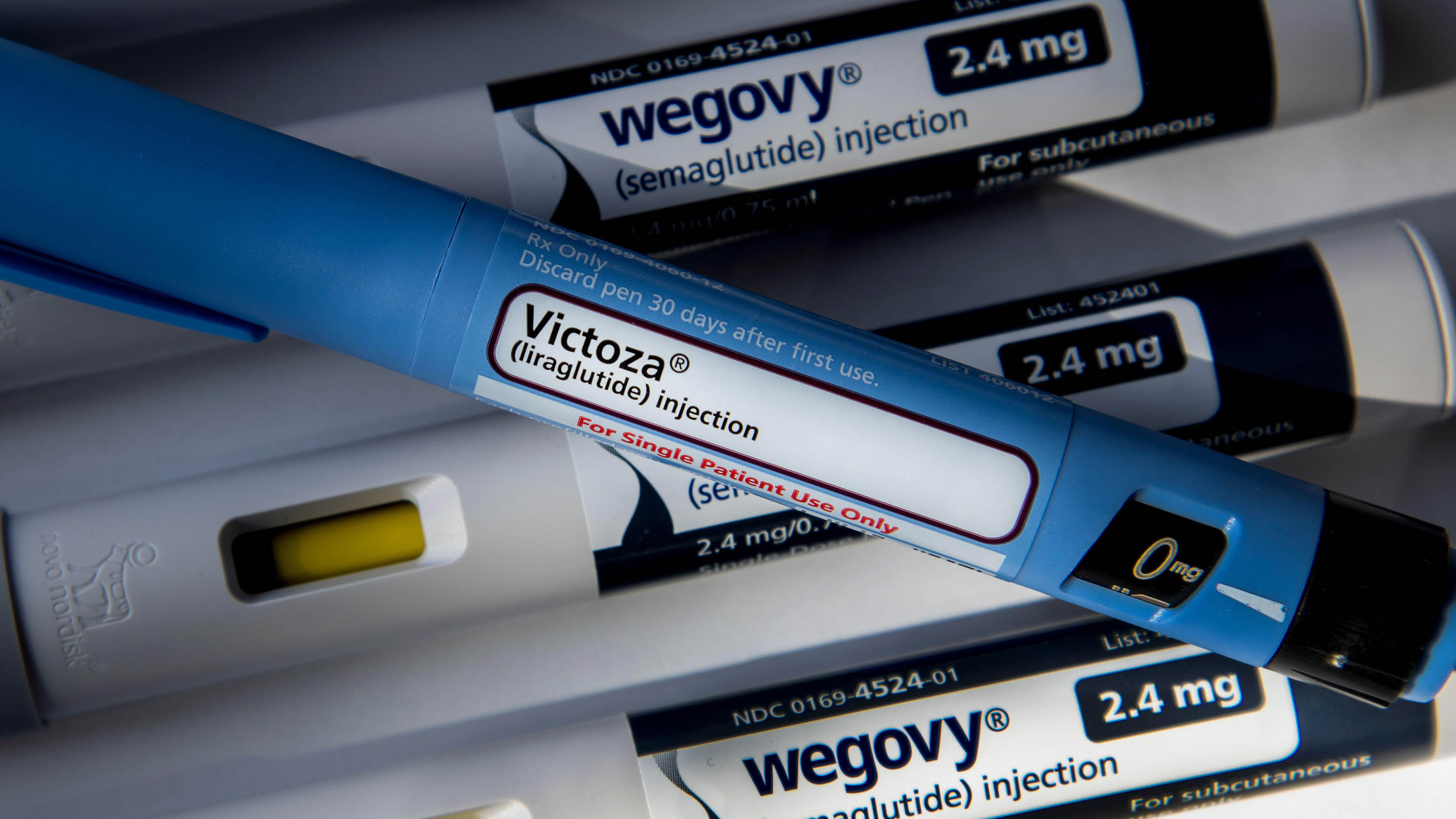 Still life of Victoza and Wegovy. Both are injectable prescription weight loss medicines.
