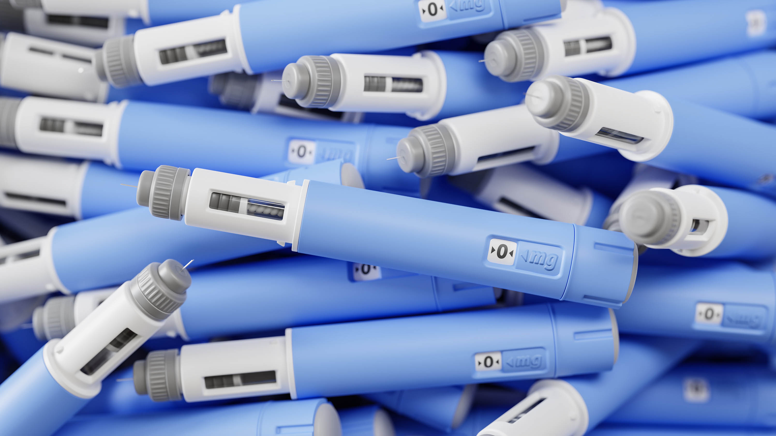 A large group of injectors / dosing pens for subcutaneous injection of anti-diabetic medication or anti-obesity medication on a heap. Selective focus.