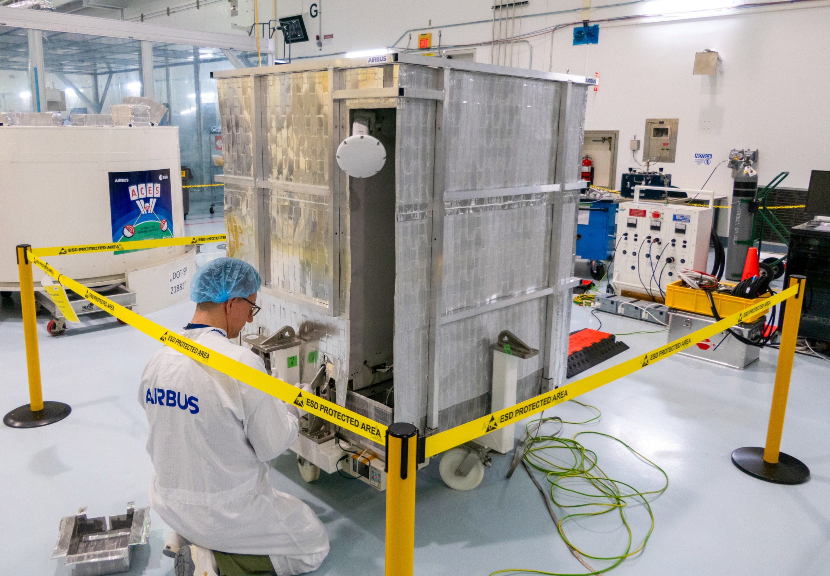 Airbus worker performs critical tests on ACES in the Space Station Processing Facility cleanroom at the Kennedy Space Center.