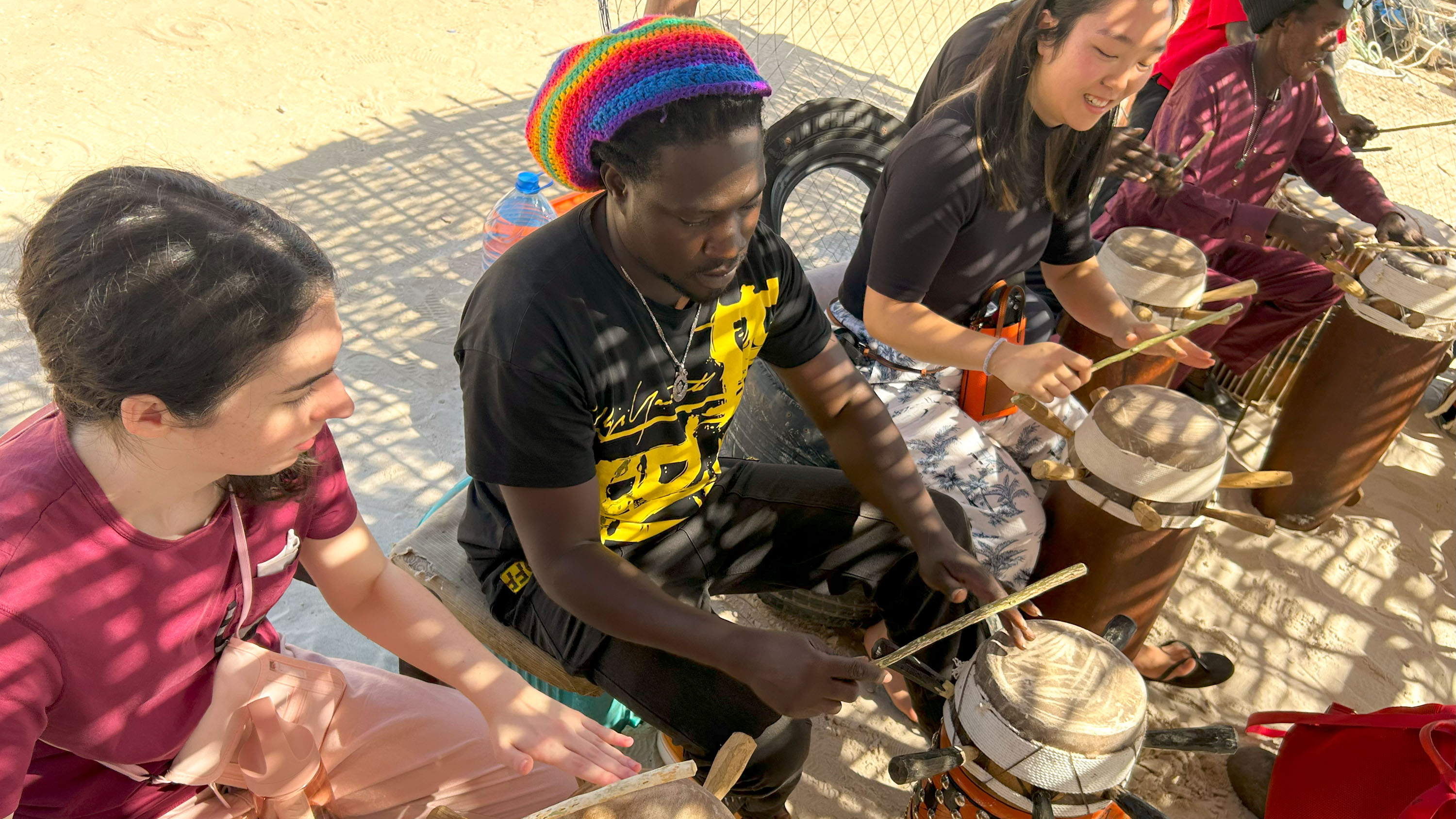 people sitting on the ground with drums
