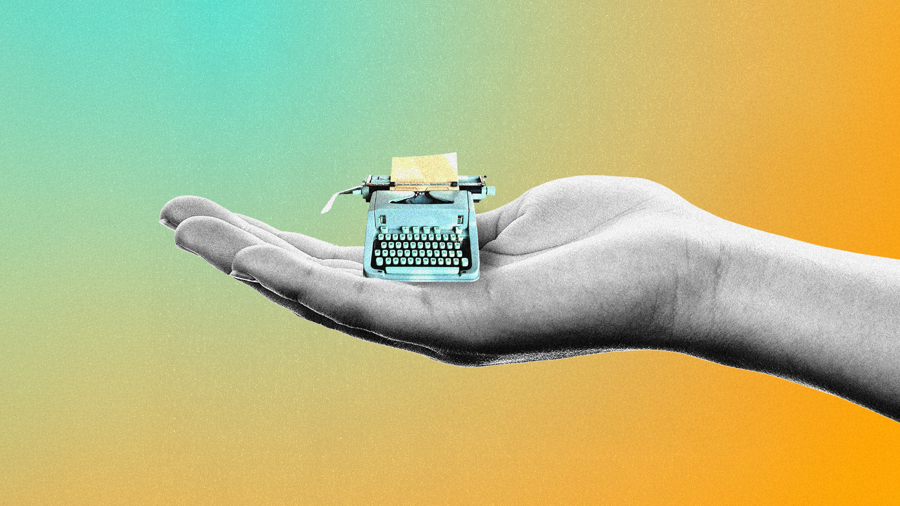 a hand with a teeny tiny typewriter